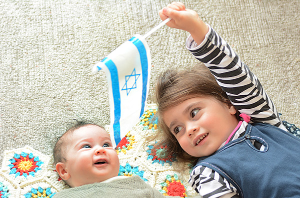 Baby and toddler with Israeli flag